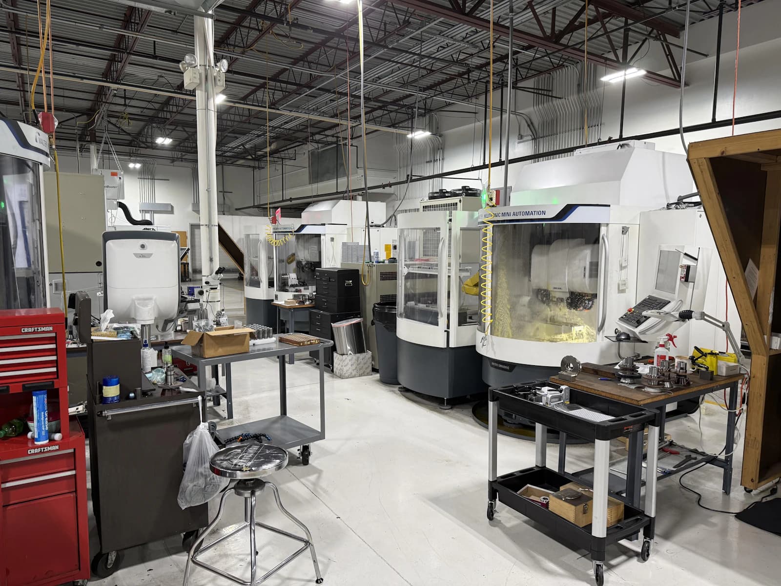 Brightly equipped industrial machinery workshop where heavy equipment hydraulics are serviced